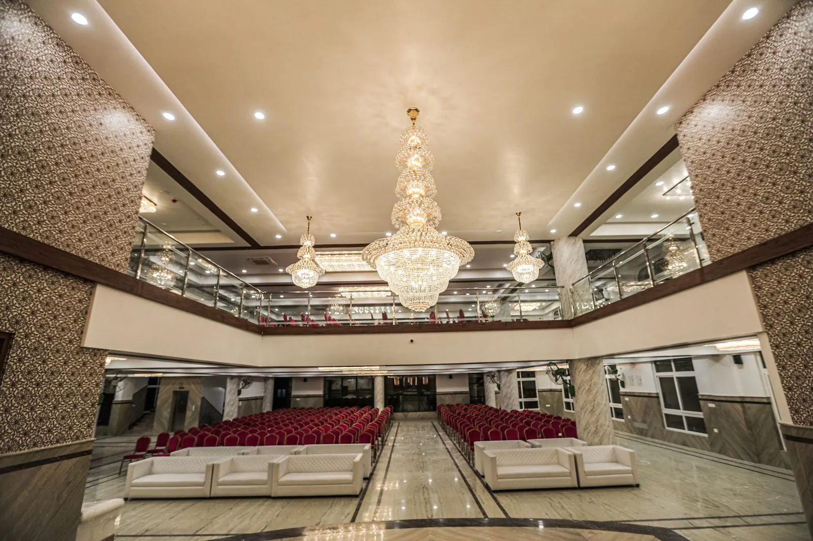 Air-conditioned marriage hall with chandelier and gallery level